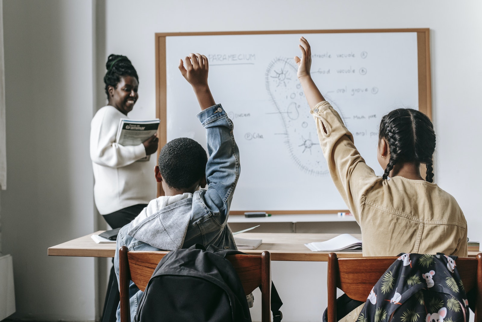 Black woman with pupils in classroom