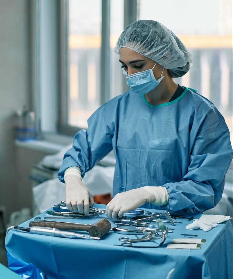 A Woman Arranging Medical Tools in an Operating Room